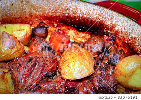 Closeup of a dish of osso buco with potatoes 83076191