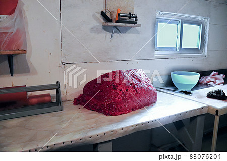 View of a pile of ground moose in an backyard meat shop View of a pile of ground moose in an backyard meat shop 83076204