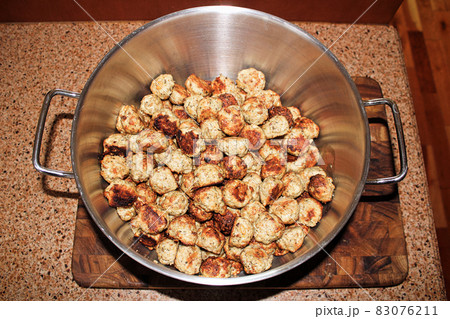 Baked meatballs piled into a silver pot 83076211