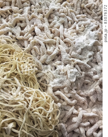 Closeup of freshly homemade floured pasta pieces 83076372