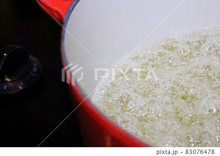 Closeup of liquid boiling in a pot Closeup of liquid boiling in a pot 83076478