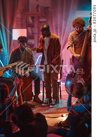 Man singing together with his band Man singing together with his band 83077093