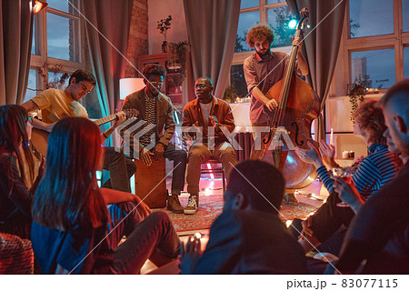 People playing in musical band 83077115