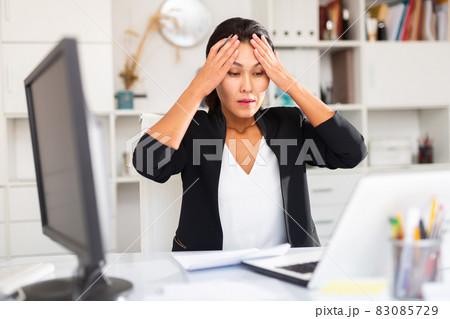 Tired businesswoman working with documents in office 83085729