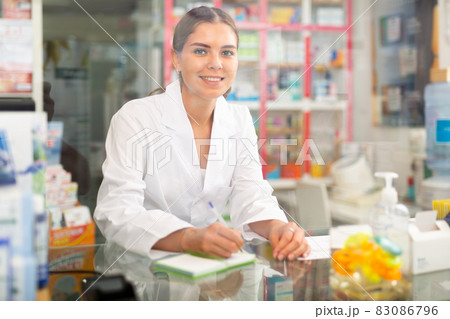 Pharmacist standing behind counter Pharmacist standing behind counter 83086796
