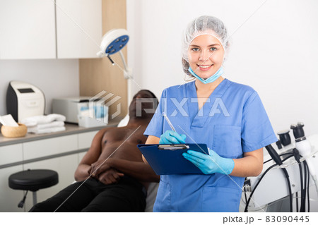 Young female doctor cosmetologist meeting client in aesthetic clinic 83090445