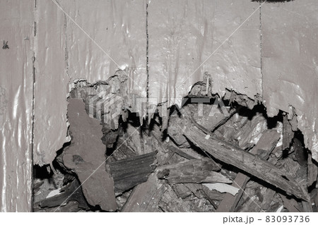 A hole in the old wooden floor. Rotten, broken boards. View from A hole in the old wooden floor. Rotten, broken boards. View from 83093736