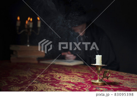 Candle on the background of the reading wizard . 83095398