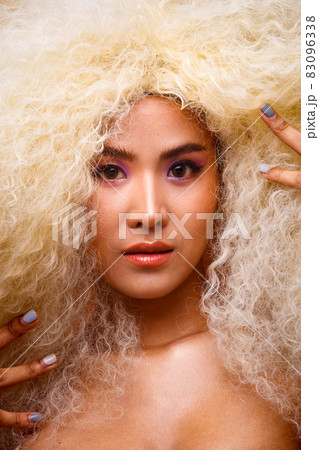 Half Body Portrait of 20s Asian Caucasian beautiful Woman blonde afro hair high fashion make up Half Body Portrait of 20s Asian Caucasian beautiful Woman blonde afro hair high fashion make up 83096338