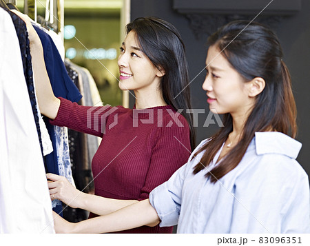 beautiful young asian women looking at apparels in a clothing store 83096351