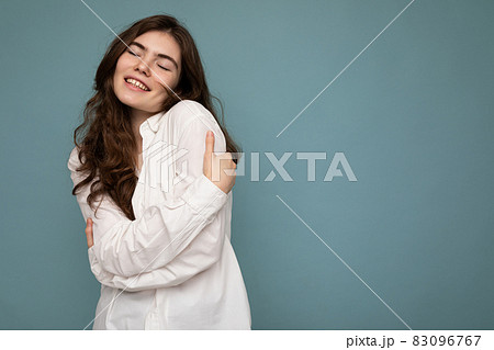 Photo of young positive happy smiling beautiful woman with sincere emotions wearing stylish clothes 83096767