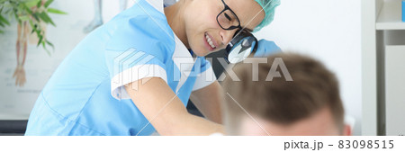 Woman doctor with glasses examining rash on skin of buttocks of young man in clinic Woman doctor with glasses examining rash on skin of buttocks of young man in clinic 83098515