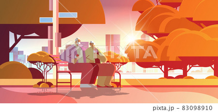 senior couple sitting on bench and eating ice cream happy grandparents spending time together in park 83098910