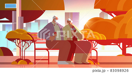 senior couple sitting on bench and eating ice cream happy grandparents spending time together in park 83098926