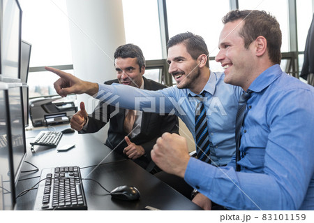 Successful business team celebrates business success in modern corporate trading office. 83101159