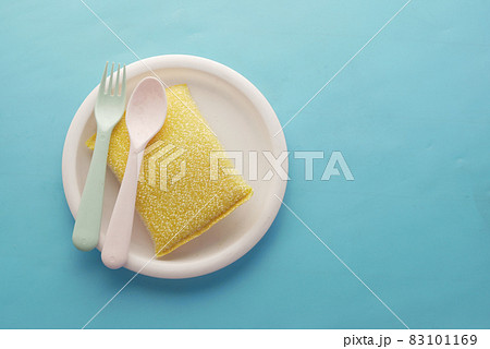 sponge , rubber gloves and colorful plate on blue sponge , rubber gloves and colorful plate on blue 83101169