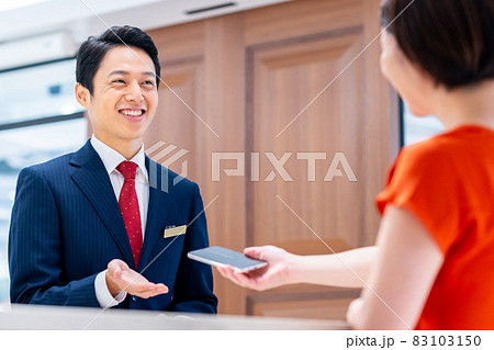 ホテルのフロントでスマホ決済する若い女性 撮影協力:WEEK芝大門(サンフロンティア不動産) ホテルのフロントでスマホ決済する若い女性 撮影協力:WEEK芝大門(サンフロンティア不動産) 83103150