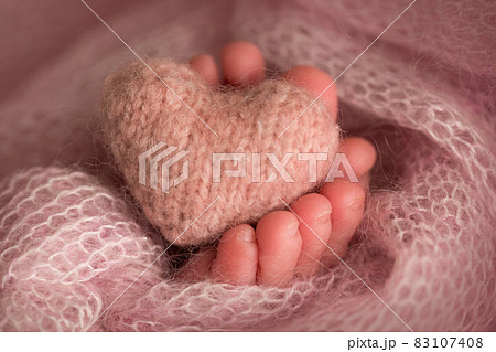 legs and toes of a newborn in a soft pink blanket with a heart legs and toes of a newborn in a soft pink blanket with a heart 83107408