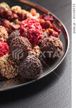 Homemade chocolate candy with nuts and dried fruits. Homemade chocolate candy with nuts and dried fruits. 83108553