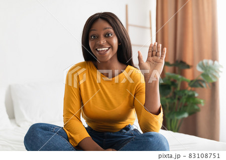Black Female Waving Hand Communicating Via Video Call At Home Black Female Waving Hand Communicating Via Video Call At Home 83108751