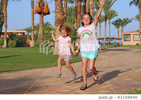 Happy childish team having fun running on path in tropic resort Happy childish team having fun running on path in tropic resort 83108940