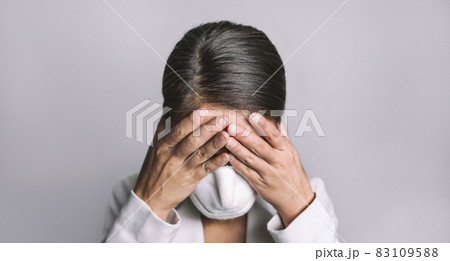 COVID-19 Stress business woman crying covering face mask with hands Coronavirus employment recession anxiety 83109588