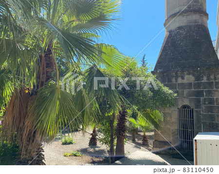 Small beautiful neat stone clay Arab Islamic Muslim houses with round domes in the desert with palm trees in a tropica Small beautiful neat stone clay Arab Islamic Muslim houses with round domes in the desert with palm trees in a tropica 83110450