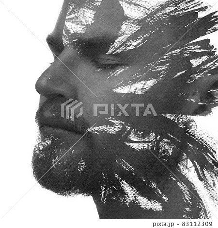 A black and white portrait of an attractive man combined with black ink strokes. Paintography. 83112309