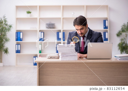 Young male employee working in the office Young male employee working in the office 83112654