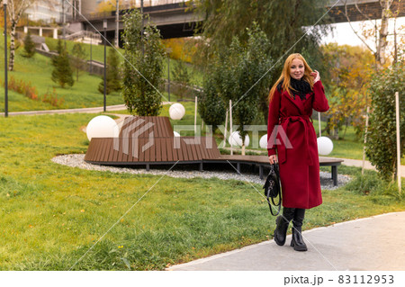young woman walking in the autumn park young woman walking in the autumn park 83112953