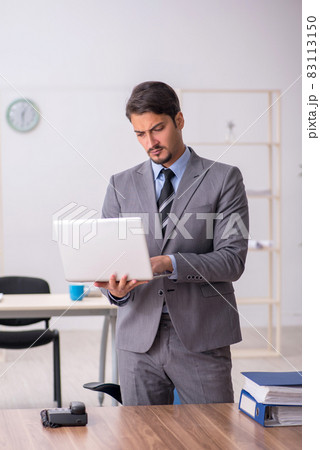 Young male employee working in the office Young male employee working in the office 83113150