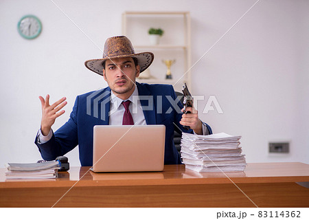 Young cowboy businessman working at workplace 83114362