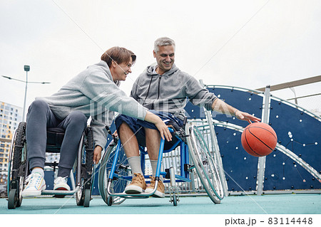 Couple of friends in wheelchairs playing together 83114448