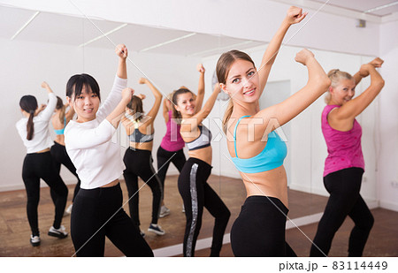 Fitness women practicing zumba movements 83114449