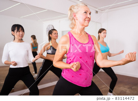 Fitness women practicing zumba movements 83114472