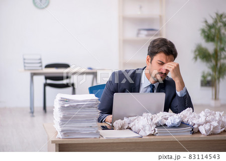 Young male employee in brainstorming concept 83114543