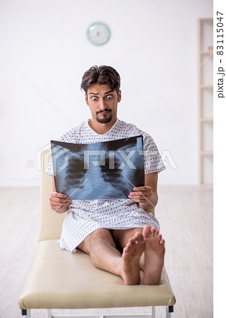 Young male patient looking x-ray in the clinic Young male patient looking x-ray in the clinic 83115047