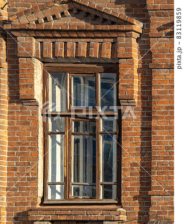 The window of the old mansion 19 century with brown bricks wall The window of the old mansion 19 century with brown bricks wall 83119859