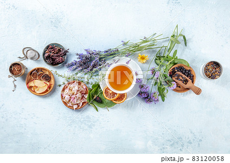 Organic tea. Herbs, flowers and fruit around a cup of tea, a flat lay, top shot 83120058