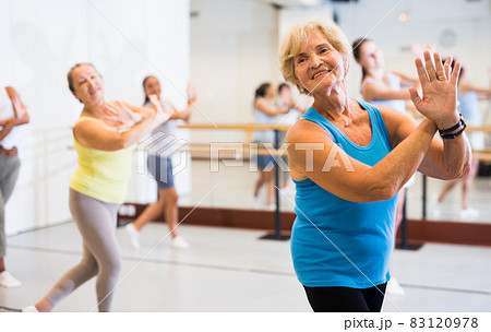Portrait of an mature European woman enjoying energetic dancing in the studio 83120978