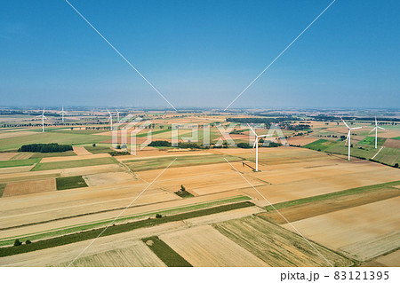 Windmill turbine in the field at summer day. Rotating wind generator Windmill turbine in the field at summer day. Rotating wind generator 83121395