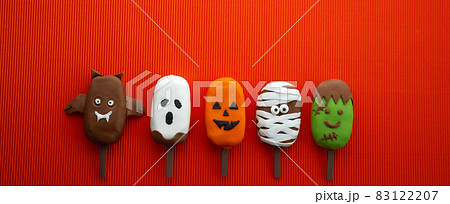Set of ice cream with halloween character face on orange background. Halloween party background. Set of ice cream with halloween character face on orange background. Halloween party background. 83122207