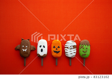 Set of ice cream with halloween character face on orange background. Halloween party background. 83123102