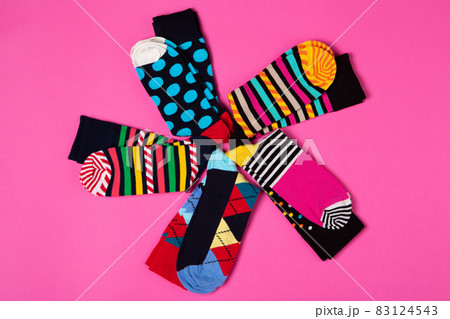 five pairs of colored socks with different patterns, laid out in the shape of a flower, on a pink background, assortment concept five pairs of colored socks with different patterns, laid out in the shape of a flower, on a pink background, assortment concept 83124543