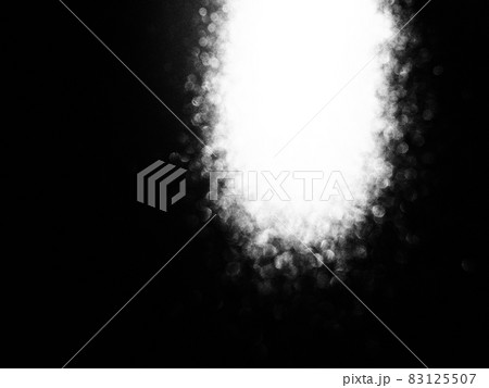 White bokeh and beam on a black background. Blurred glow from above on a dark surface. Night or space theme. Bokeh for the holiday. Association for a flying meteorite. Abstract theme White bokeh and beam on a black background. Blurred glow from above on a dark surface. Night or space theme. Bokeh for the holiday. Association for a flying meteorite. Abstract theme 83125507
