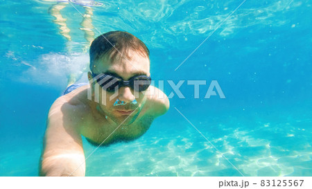 A man swimming under the water, Mediterranean sea A man swimming under the water, Mediterranean sea 83125567