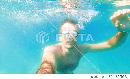 A man swimming under the water, Mediterranean sea A man swimming under the water, Mediterranean sea 83125568