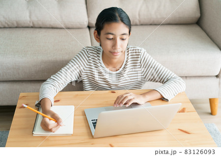 Asian girl learning online via the internet tutor on a laptop computer Asian girl learning online via the internet tutor on a laptop computer 83126093
