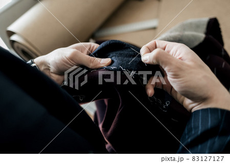 Tailor hands working in tailor shop 83127127