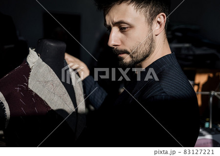 Handsome serious tailor in suit 83127221